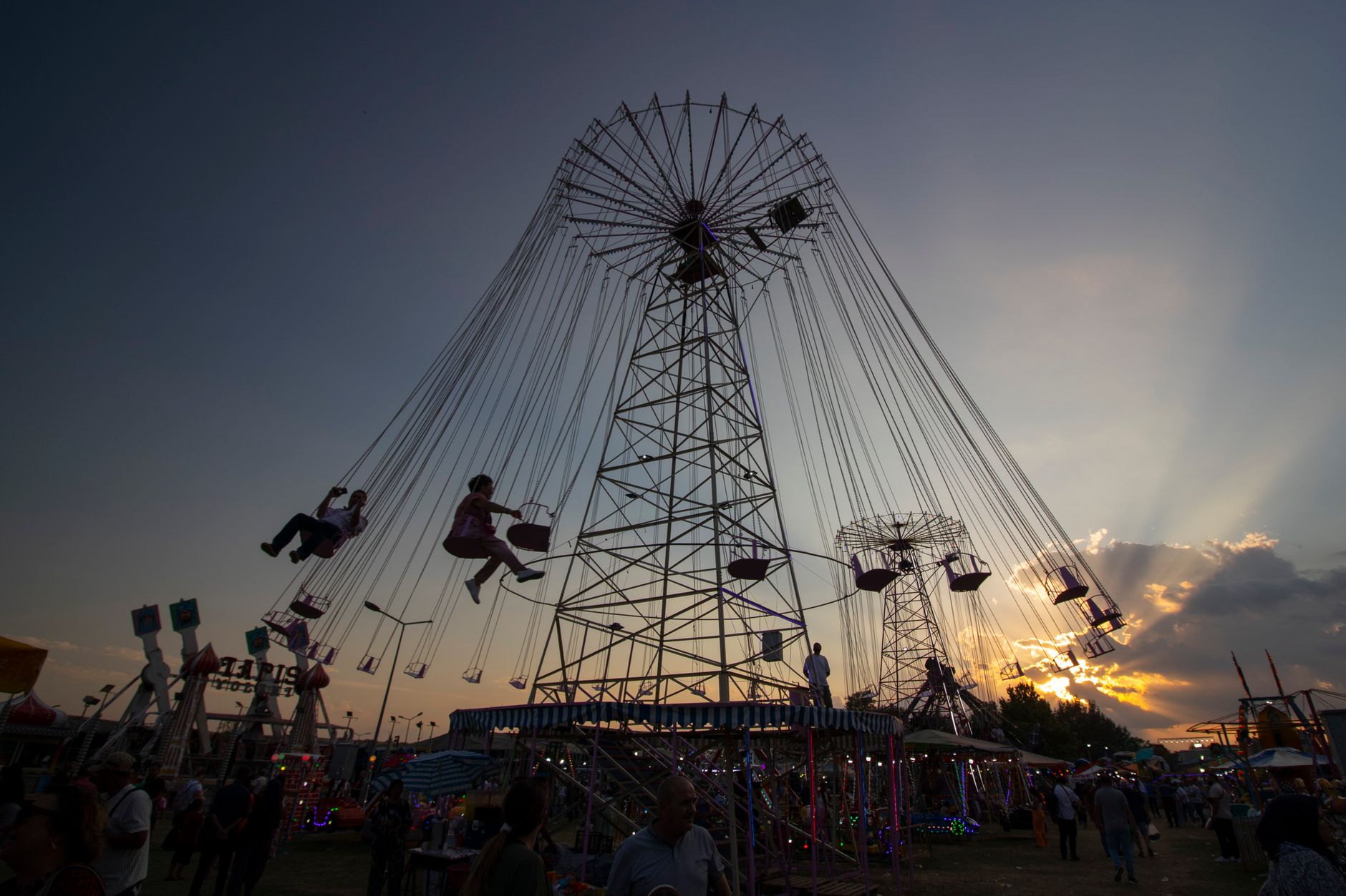 vibrant carnival swing ride at sunset