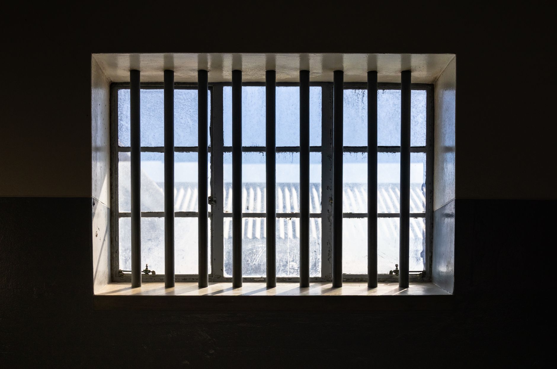 sunlight through prison cell window bars